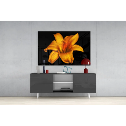 Vibrant yellow lily glass wall art on glossy black canvas