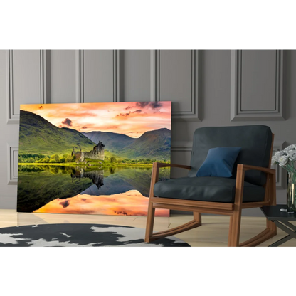 Castle reflected in calm waters under orange sunset glass wall art print