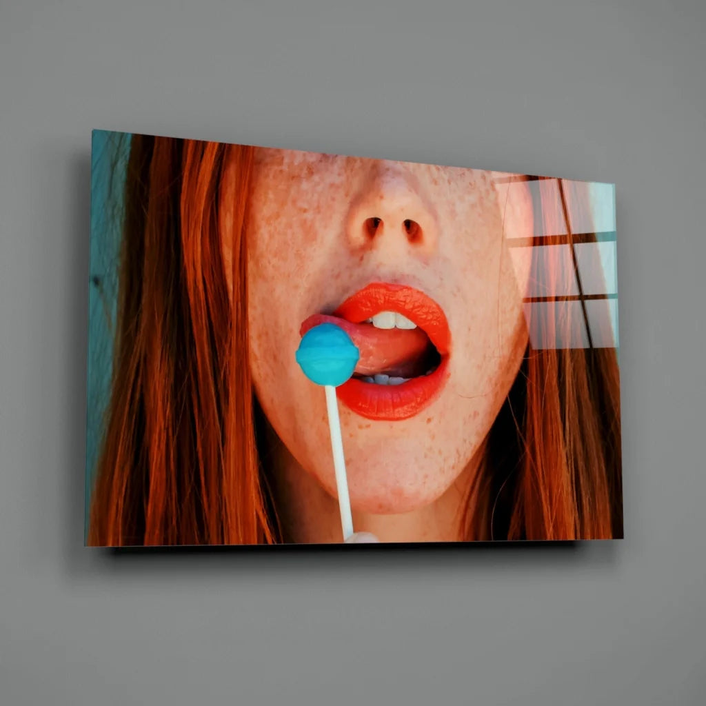 Vibrant pop art redhead glass wall art with freckled woman and blue lollipop