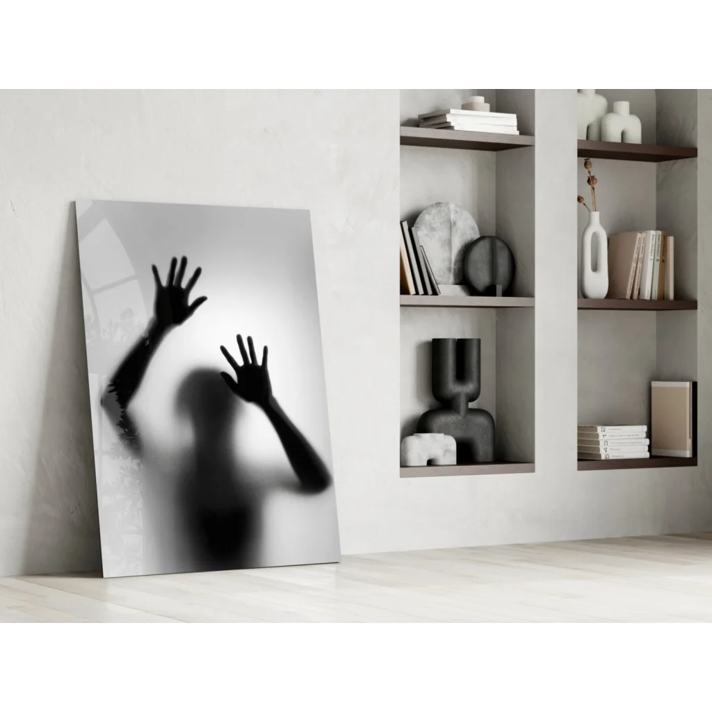 Black and white glass wall art print of hands on frosted surface