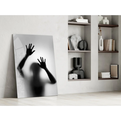 Black and white glass wall art print of hands on frosted surface
