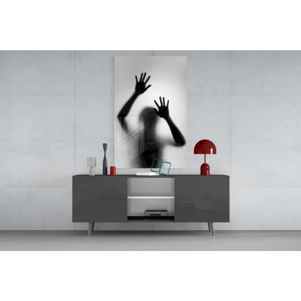 Black and white glass wall art print of raised hands silhouette on frosted surface