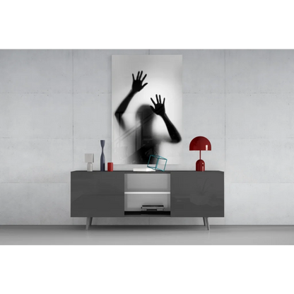 Black and white glass wall art print of raised hands silhouette on frosted surface