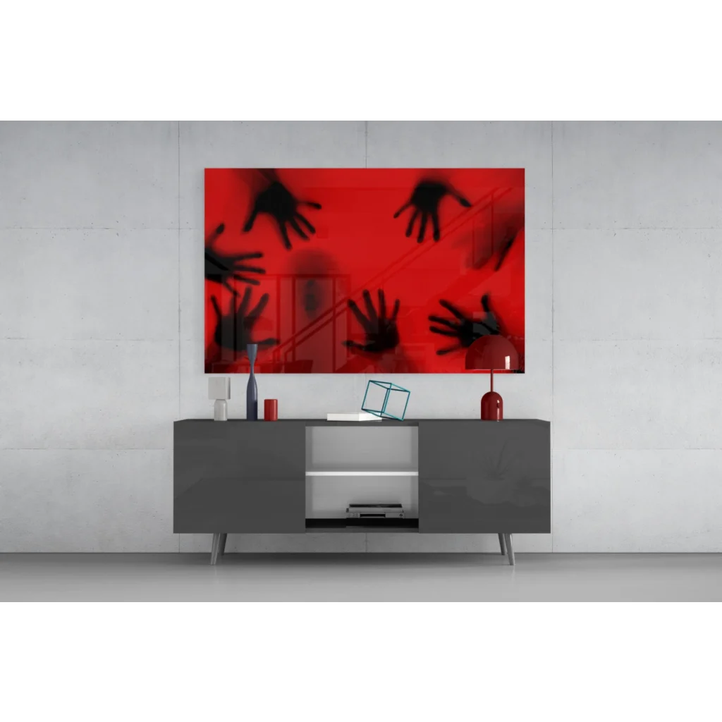 Vibrant red glass wall art with bold black hand silhouettes