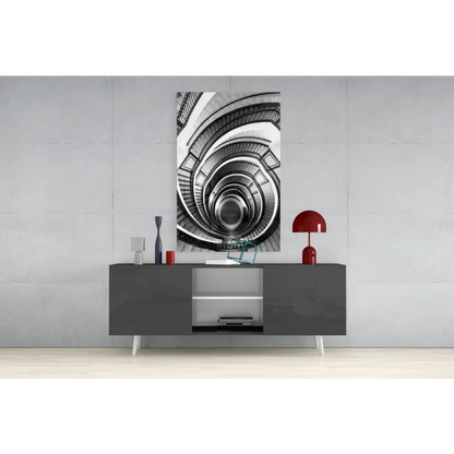 Black-and-white spiral staircase glass wall art on gray wall above console table