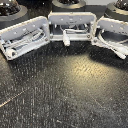 Lot includes white plastic bases with wiring for Alarm.com home surveillance cameras