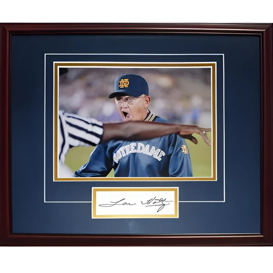 A framed lou holtz autographed signature series frame featuring a man in a blue notre dame baseball uniform and cap