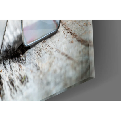 Sleek silver smartphone on gray stone with Love Roses glass wall art