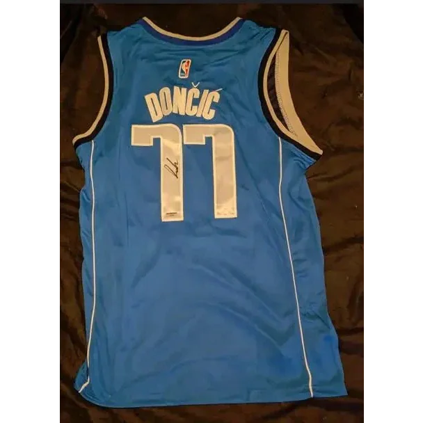 Blue Luka Doncic autographed Dallas Mavericks jersey with faded signature and certificate