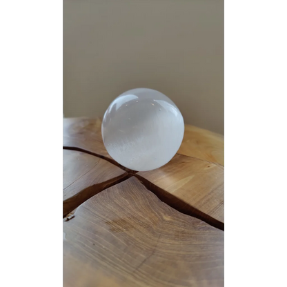 Luminous Moroccan selenite sphere 8cm on wood
