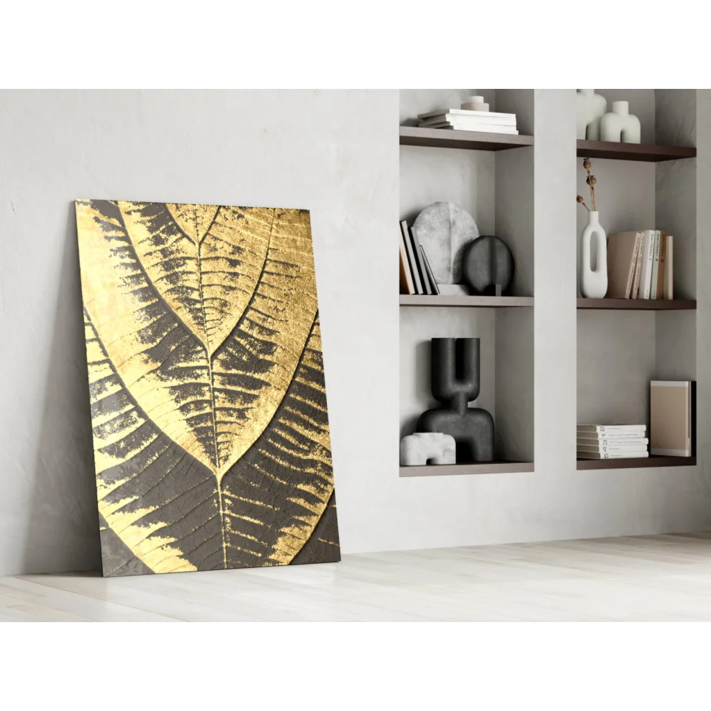Striking gold leaf wall art with black patterns on canvas against white wall
