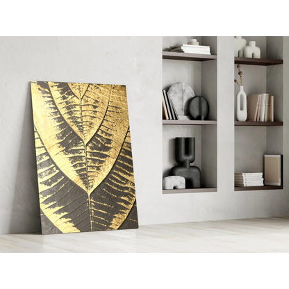 Striking gold leaf wall art with black patterns on canvas against white wall