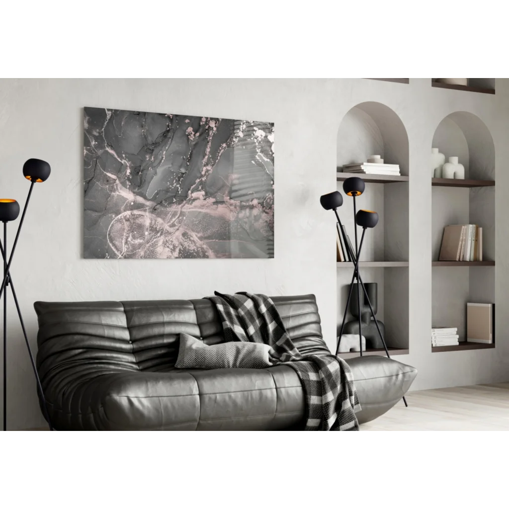 Black leather sofa with tufted cushions and plaid throw in Luxe Rose Gold Marble wall art