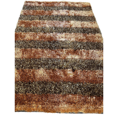 Shaggy striped wool rug in earthy browns, tans and grays with high pile texture