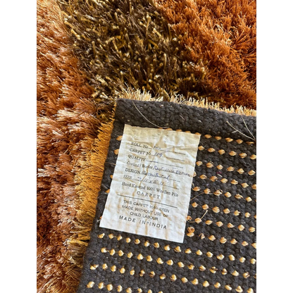 Shaggy striped wool rug in earthy browns, golds and grays with plush deep pile
