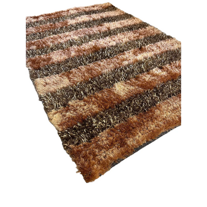 Shaggy striped wool rug in earthy browns, tans and grays showing full rug view
