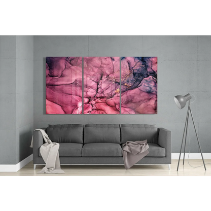 Vibrant pink purple swirl glass wall art triptych above gray sofa