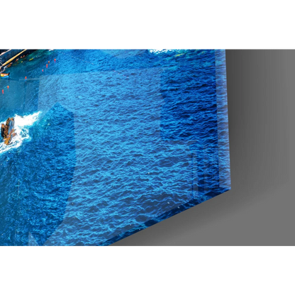 Vibrant blue glossy glass wall art of coastal village with water ripples
