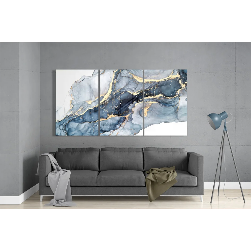 Blue and gold insigne glass art triptych with marble swirls above gray sofa