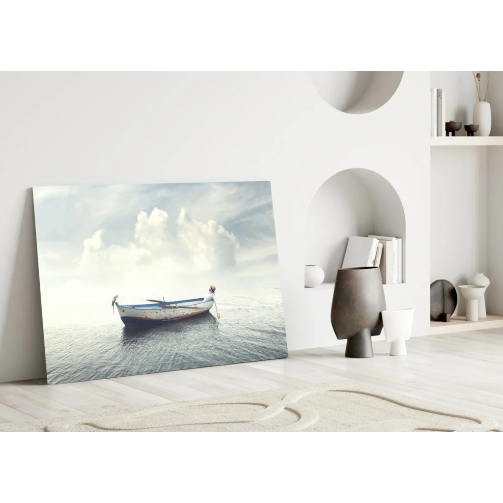 Solitary figure by weathered boat on calm waters, serene glass wall art print