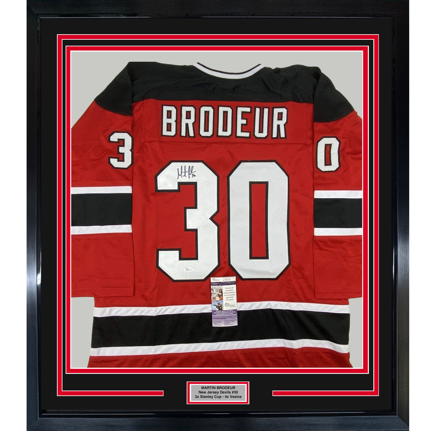 Framed red, black, and white New Jersey Devils #30 hockey jersey signed by Martin Brodeur, displayed front-facing with authentication certificate.