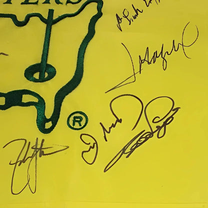 Yellow Masters pin flag with green logo and autographs by 16 champions