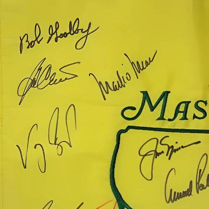 Masters yellow golf bag with green logo and 16 champion signatures on pin flag