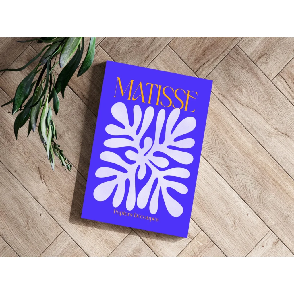 Vibrant blue Matisse book with white leaf cutout and gold title on aluminum art print