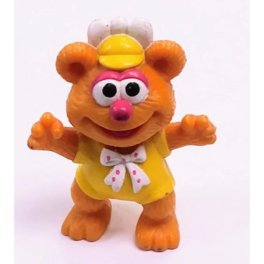 Vintage 1986 McDonalds Happy Meal Muppet Babies Fozzie Bear toy in orange with yellow dress and pink bow