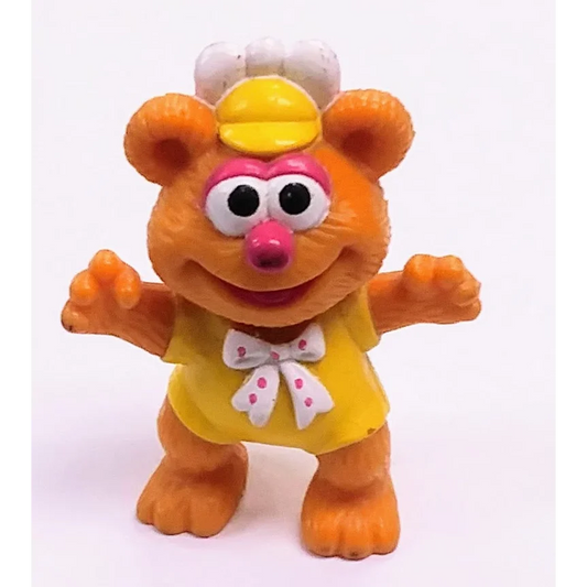 Vintage 1986 McDonalds Happy Meal Muppet Babies Fozzie Bear toy in orange with yellow dress and pink bow