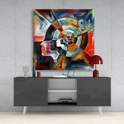 Vibrant glass wall art with bold abstract faces in swirling red, orange, blue, black, white colors