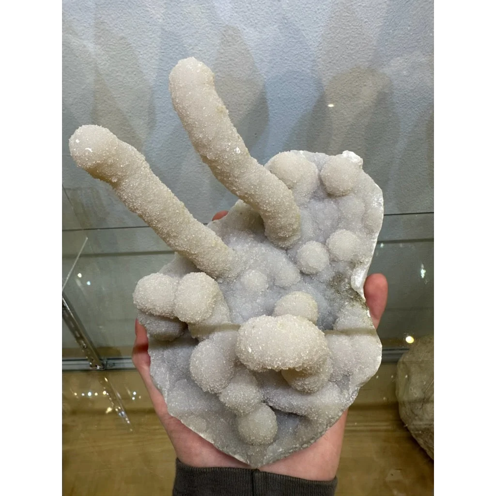 Medium chalcedony stalactite hand geode with white crystal fingers from India