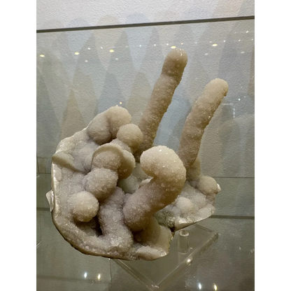 Medium chalcedony stalactite hand geode from India with white crystals