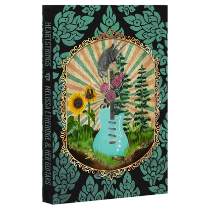 Hardback Melissa Etheridge Heartstrings Deluxe Guitar Book Set with ornate cover featuring guitar, sunflowers, and a bird
