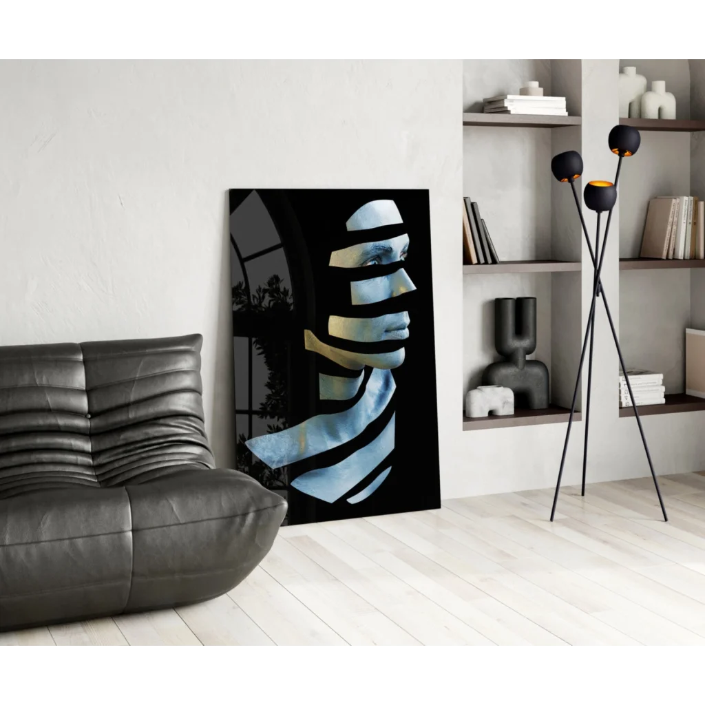 Stylized blue white face in black frame on metallic gold glass wall art