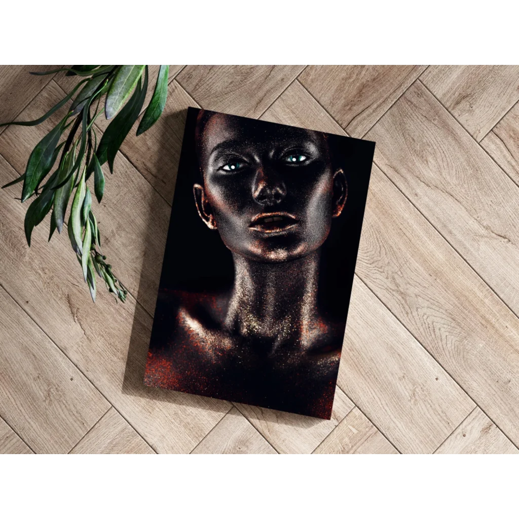 Black canvas print of woman with metallic gold glitter makeup and glowing blue eyes