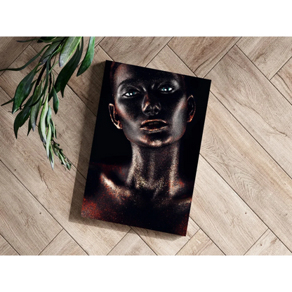 Black canvas print of woman with metallic gold glitter makeup and glowing blue eyes