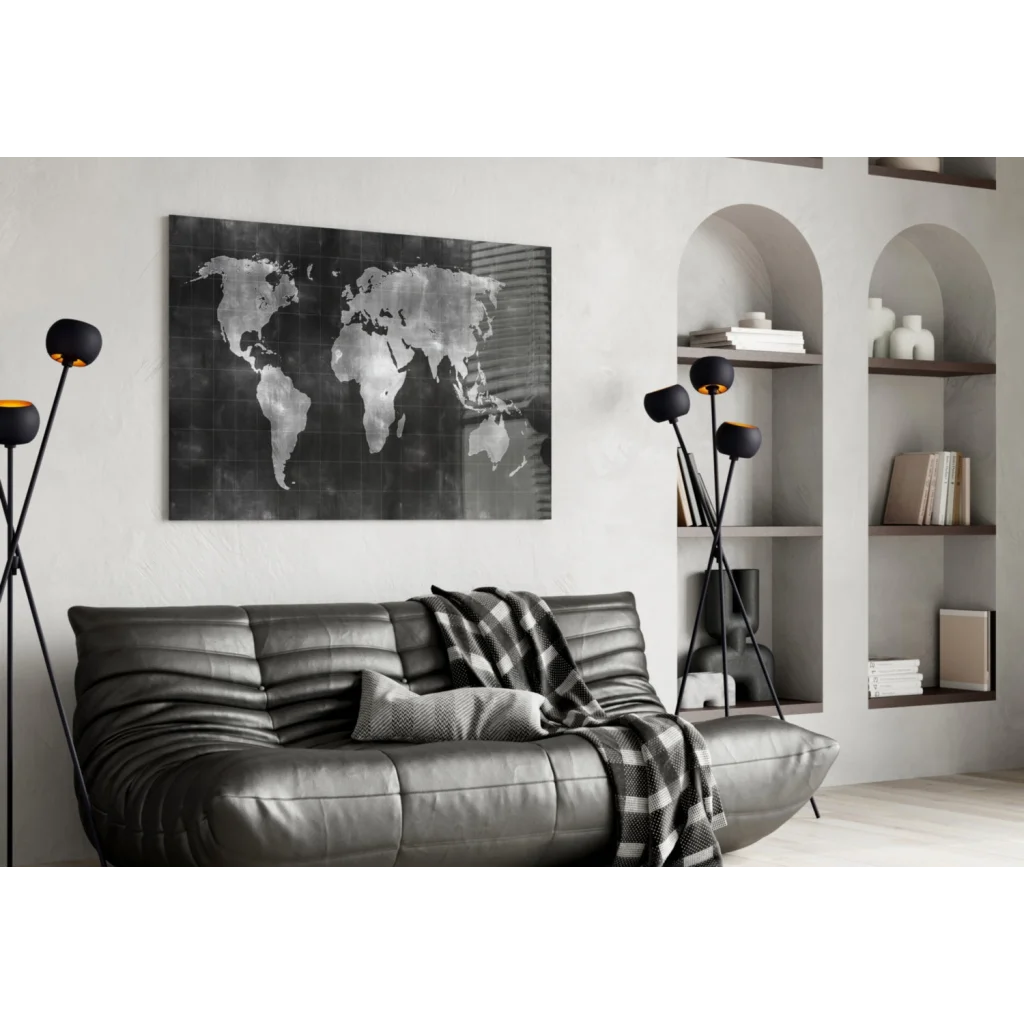 Black leather sofa with tufted cushions and plaid throw over metallic silver world map wall art