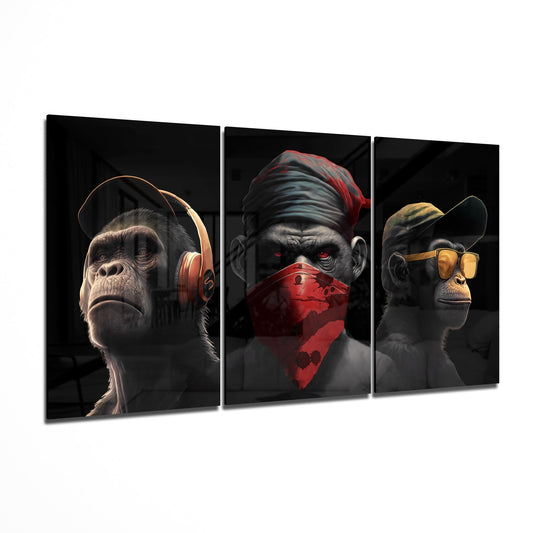 Three glass panels displaying stylized monkeys wearing headphones, red bandana, and yellow goggles against dark backgrounds, shown at an angle.