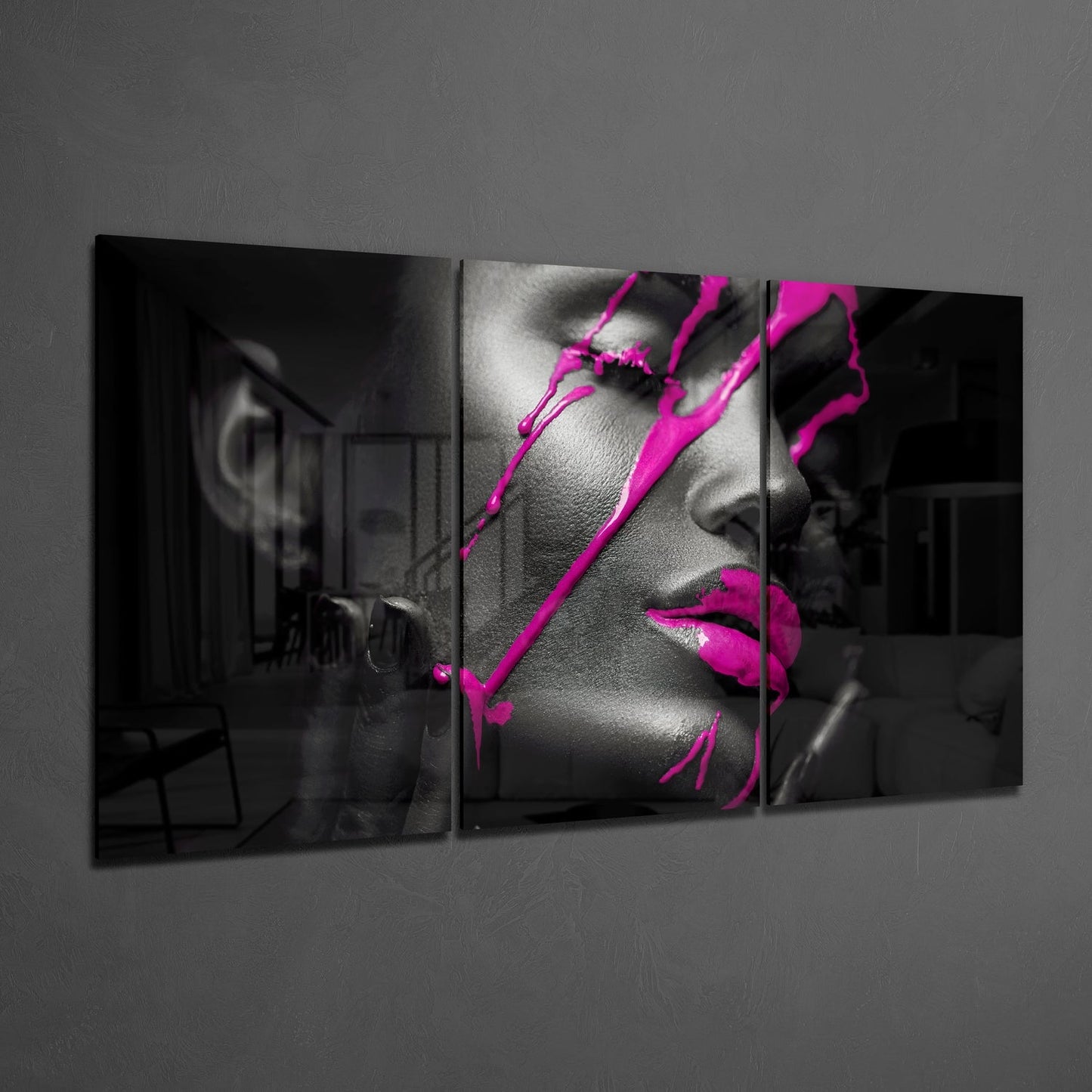 Three-panel glass wall art displaying black and white portrait with vibrant magenta ink splashes across face and lips.