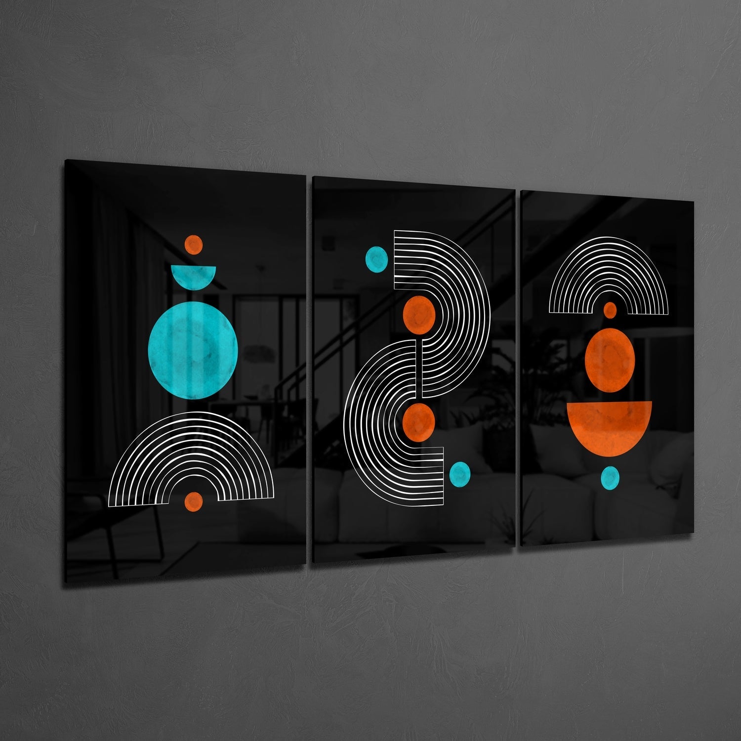 Three black glass panels with white linear semicircles and cyan and orange geometric circles displayed at an angle against a gray wall.