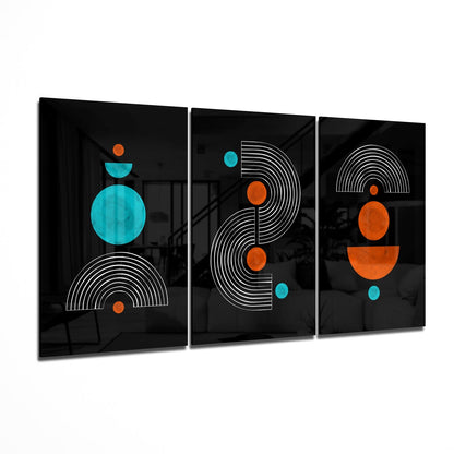 Three black glass panels with geometric designs in white lines, orange and turquoise circles arranged vertically, displayed at an angle.