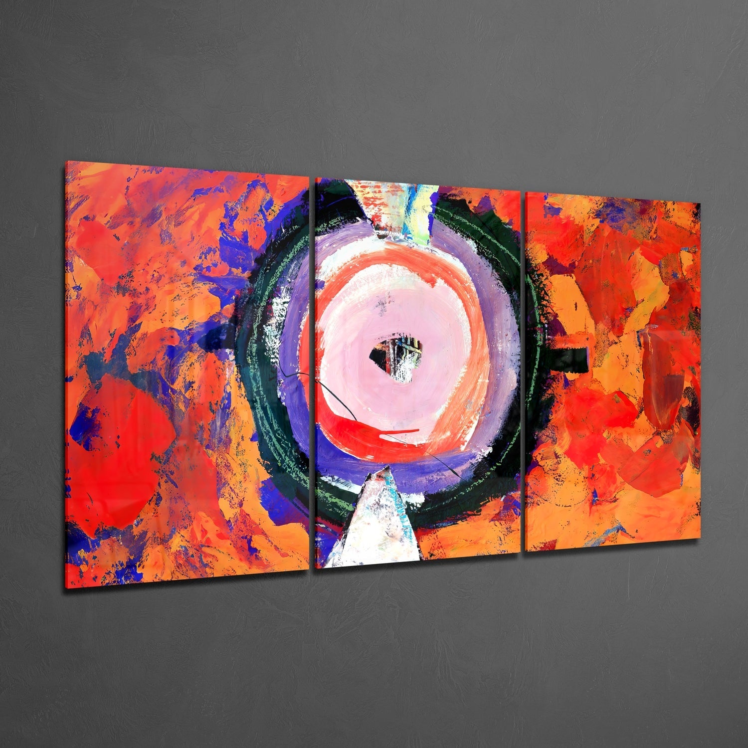 Three-panel glass wall art displaying vibrant red, orange, and blue abstract composition with a central circular pink and white focal point.