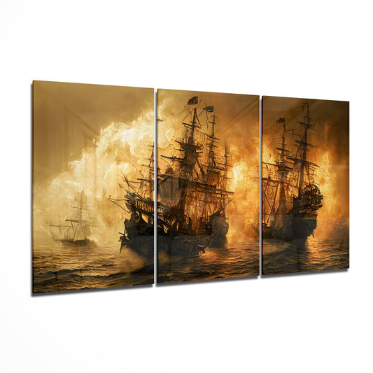 Three-panel glass wall art featuring golden-lit sailing ships in battle with explosions and smoke at sea.