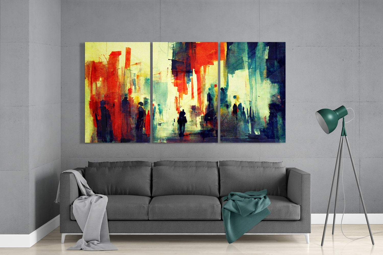 Three-panel glass wall art displaying an abstract watercolor street scene with red, yellow, green, and blue tones, hung above a gray sofa in a modern living room.
