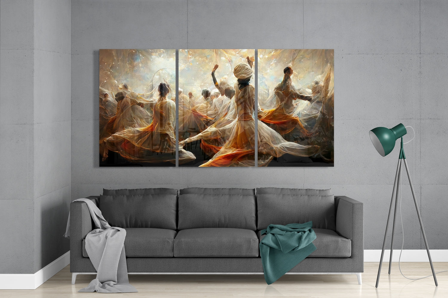 Three-panel glass art above gray sofa depicting ethereal figures in flowing orange and white fabrics dancing in golden light.
