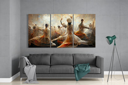 Three-panel glass art above gray sofa depicting ethereal figures in flowing orange and white fabrics dancing in golden light.