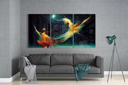 Three-panel glass wall art depicting glowing figures in flowing golden and red garments against a starry night sky, displayed above a gray sofa in a modern living room.