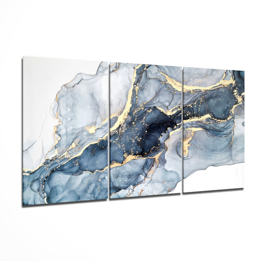 Three-panel glass wall art with blue and white marbled design accented by gold veining, displayed at an angle.
