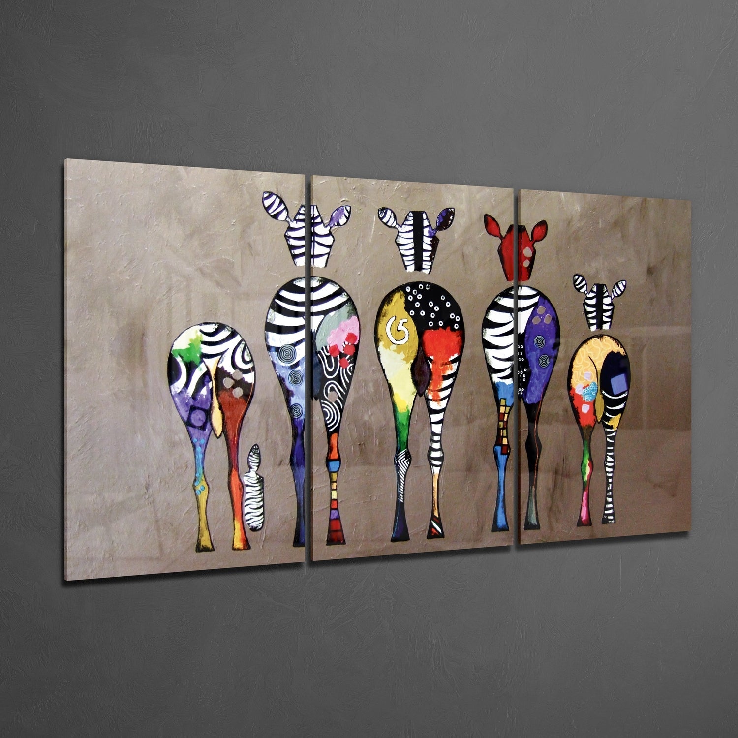 Three-panel glass wall art displaying stylized zebras with striped legs and colorful patterned bodies against a beige textured background.